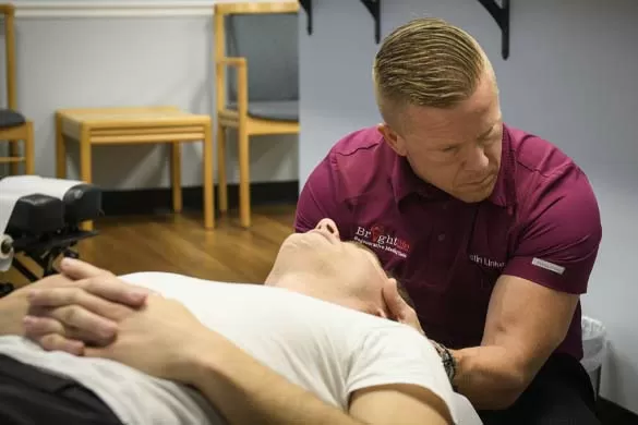 Chiropractor Schaumburg IL Justin Linker Adjusting Patient